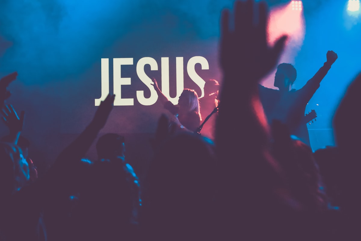 A worship gathering with raised hands